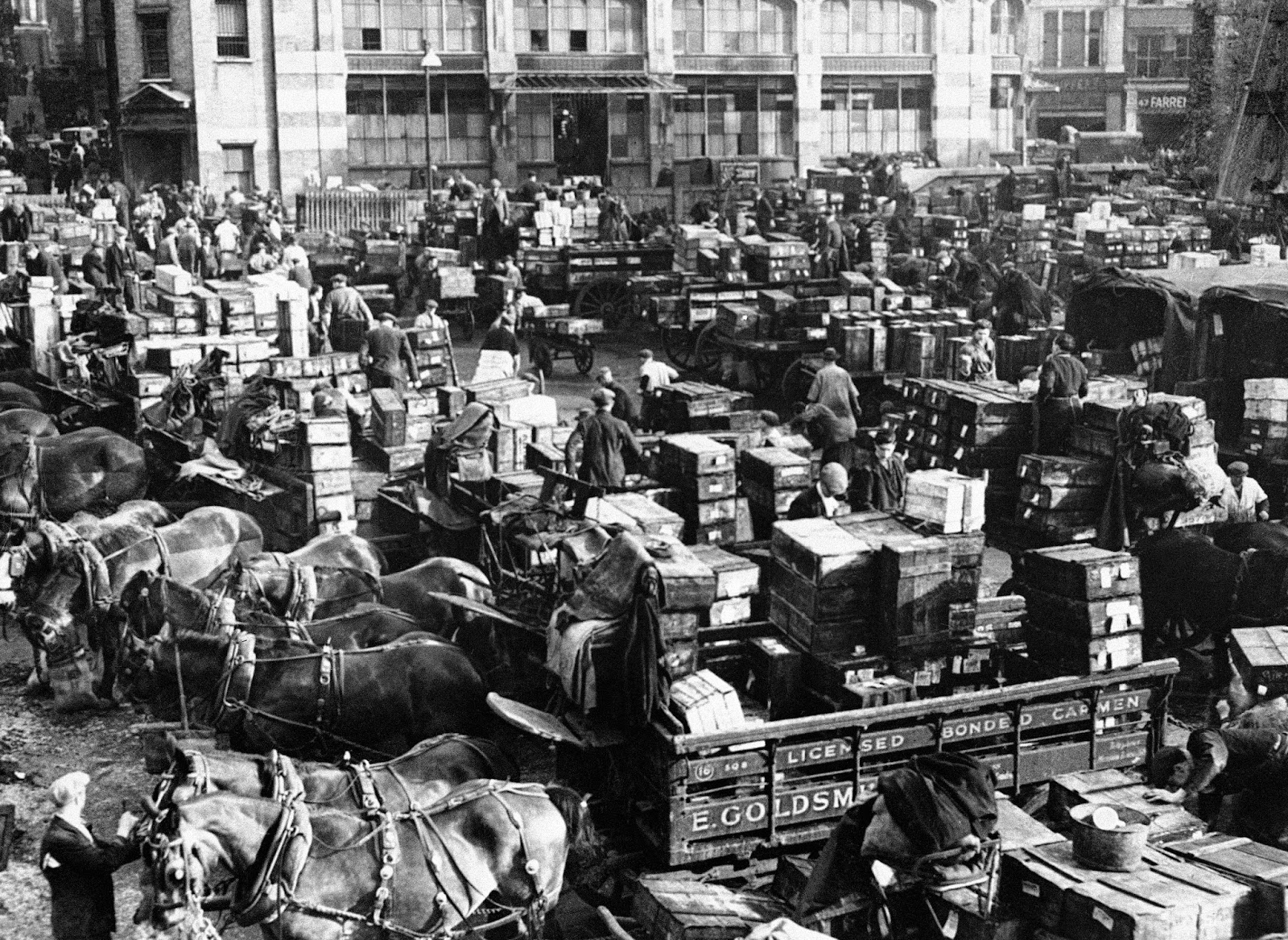 Billingsgate fish market in London, circa 1900 — merchants trading with horse-drawn carts and crates of fish